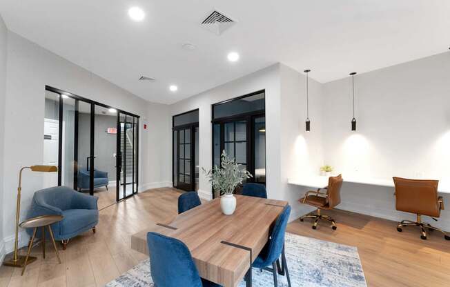 A modern dining room with a wooden table and blue chairs.