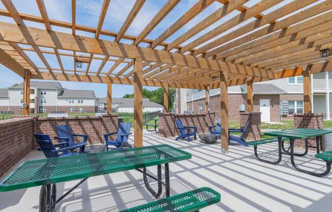 Crossing at Grove Citys clubhouse patio with green picnic tables