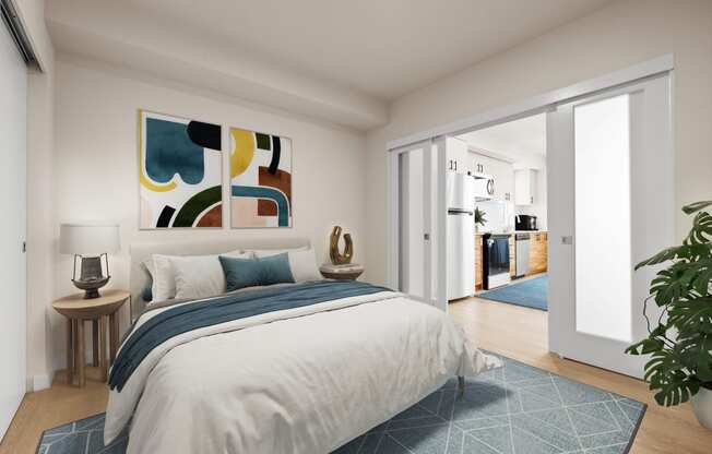 a bedroom with white walls and a large bed with blue and white bedding at Ion Town Center, Shoreline, WA