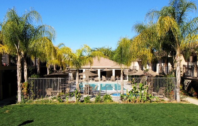 grassy area near the gated pool area at Cypress Villas Apartments