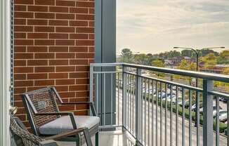 A balcony with a chair and a table.