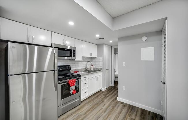 a kitchen with a sink and a refrigerator