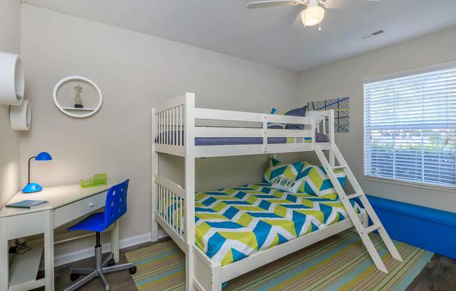 White bunk bed and corner desk in a bedroom at Ashley Oaks Apartments in Greensboro, North Carolina