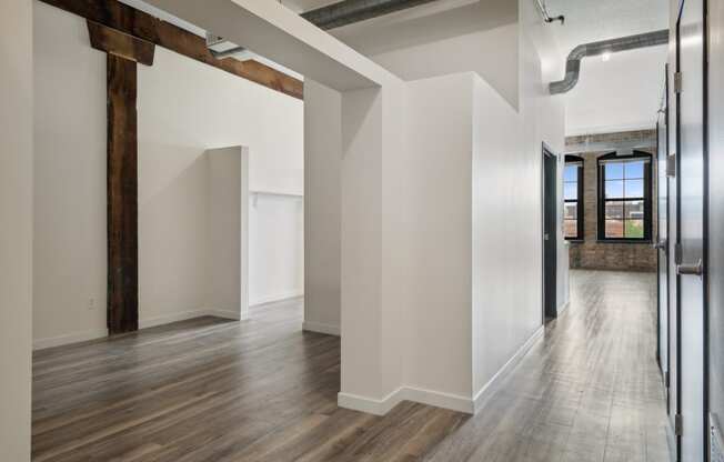 a large empty room with white walls and a wooden floor at Gaar Scott Historic Lofts, Minneapolis, Minnesota