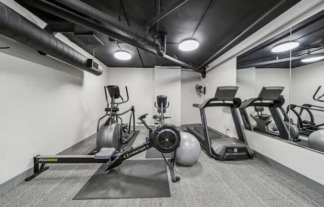 Fitness center with free weights and strength-training equipment at River 595