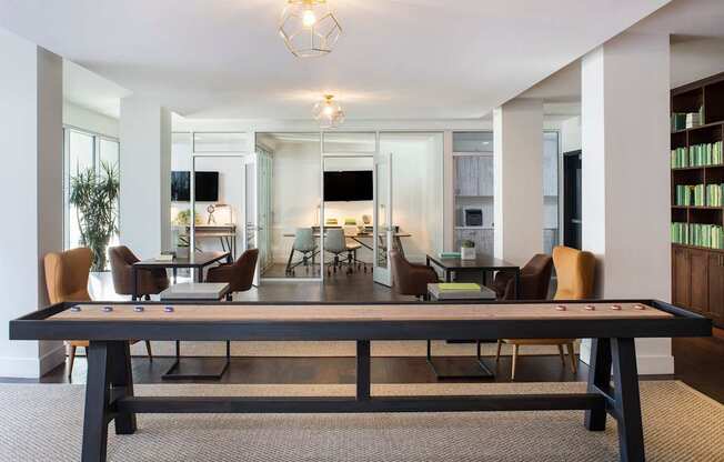 A conference room with a long table and chairs.