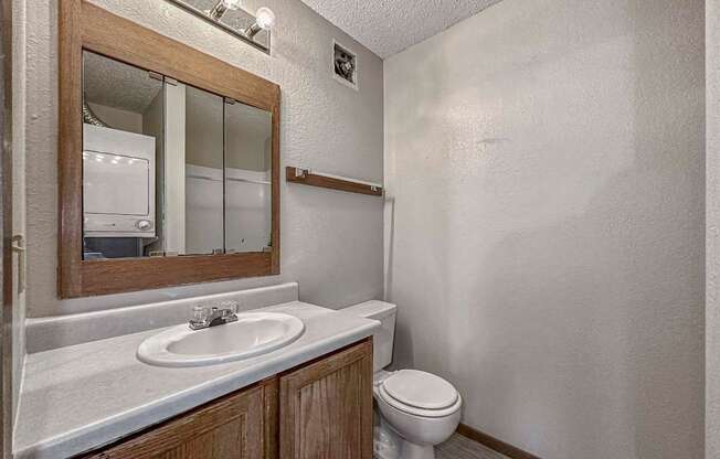 a bathroom with a toilet sink and a mirror at Creekstone Falls, South Dakota, 57106