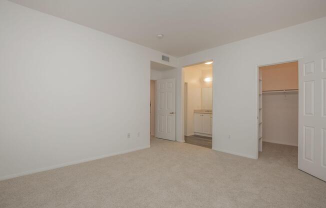 Bedroom with open walk-in closet door