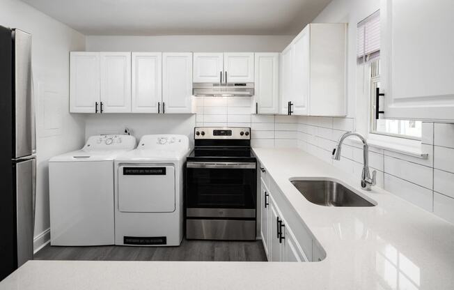 a white kitchen with white appliances and white cabinets