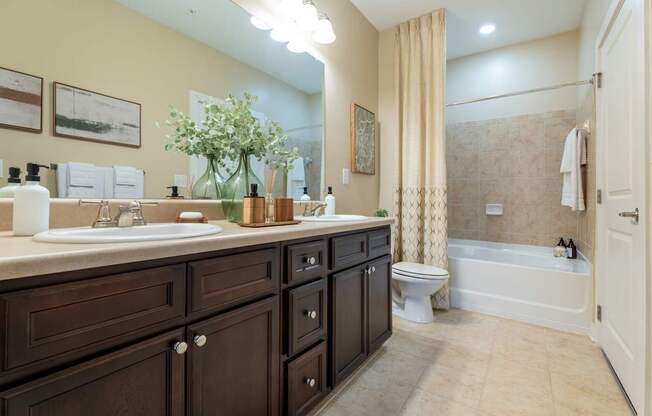 A bathroom with a sink, toilet, and bathtub.