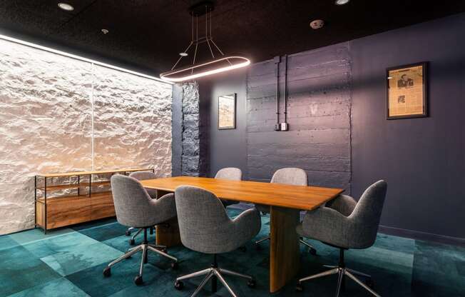 a conference room with a wooden table and chairs