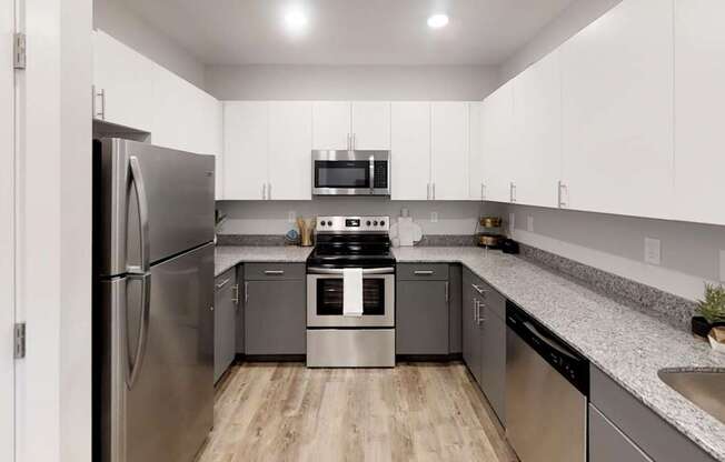 a kitchen with stainless steel appliances and granite counter tops at Echo Park at Perry Crossing Apartments, Plainfield, 46168