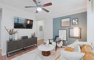 a living room with a couch and a ceiling fan