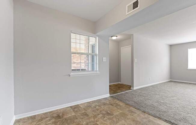 the spacious living room and dining room in a new home