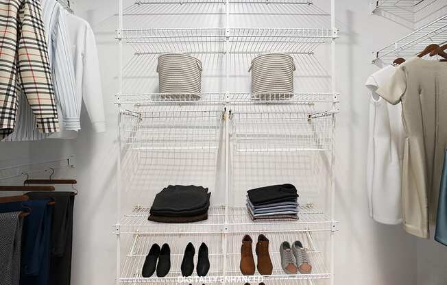A walk in closet with wardrobe organizers at Lynbrook Apartments and Townhomes, Elkhorn, NE, 68022
