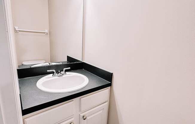 a small bathroom with a sink and a mirror