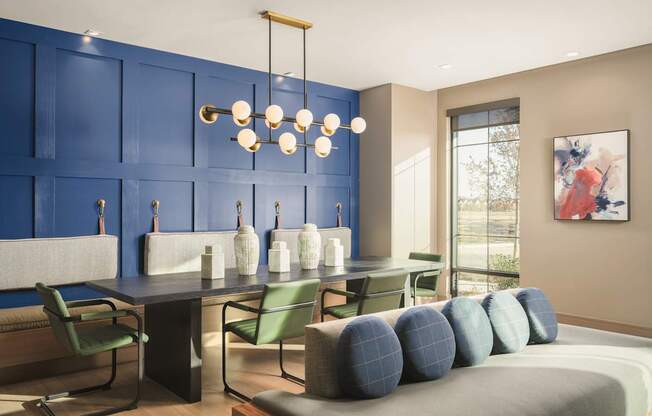 A modern living room with blue walls and furniture.