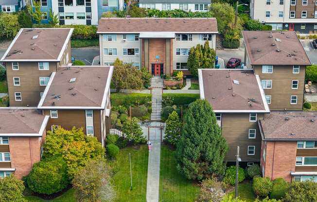 Apartment complex with a central courtyard and a red sign on the building.