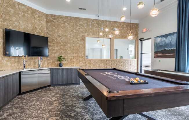 a game room with a pool table and a tv