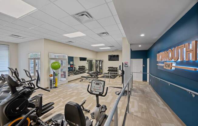 A gym with exercise equipment and a sign that says "MORNINGOUT".