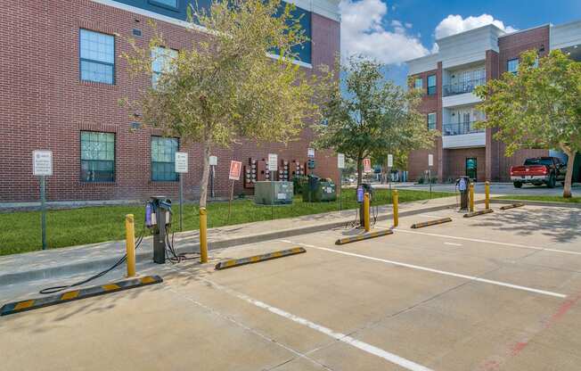 an empty parking lot in front of a brick building