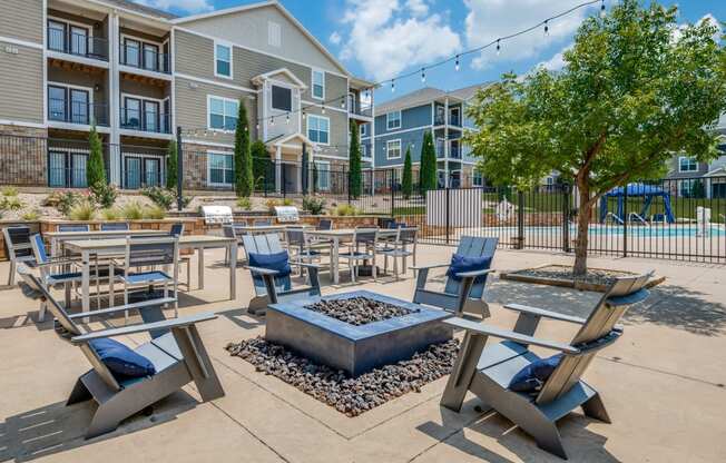 an outdoor patio area with tables and chairs and an apartment building