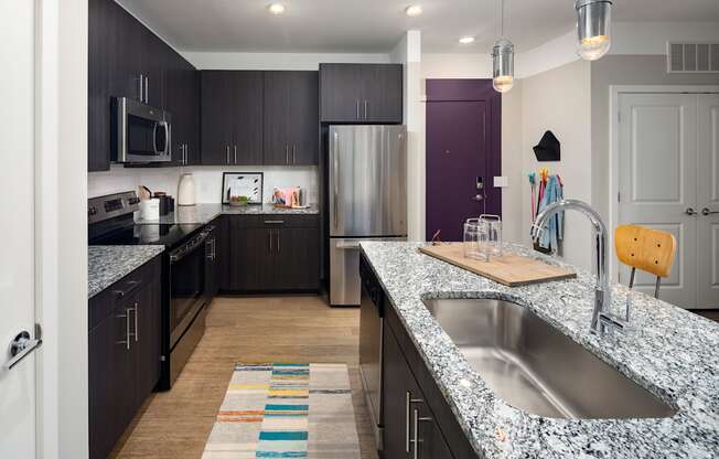 kitchen with granite countertops at the enclave at woodbridge apartments in sugar land, tx  at Abberly Noda Vista Apartment Homes, Charlotte, North Carolina