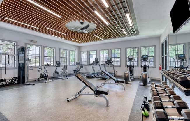 a large fitness room with treadmills and other exercise equipment