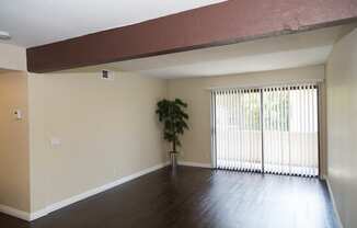 living room with plant and entrance to balcony