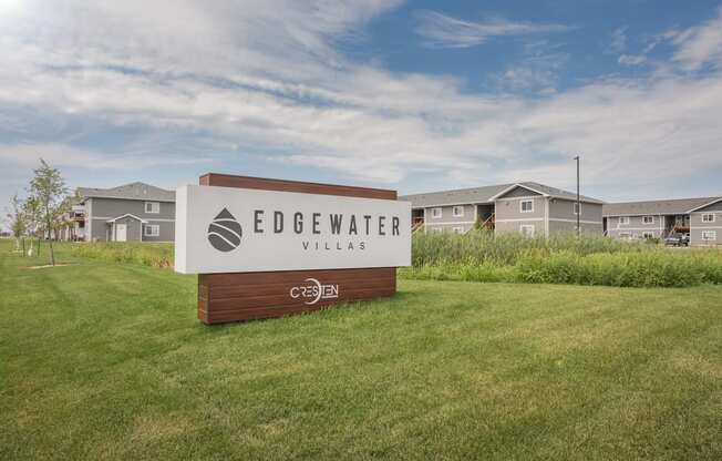 the preserve at edgewater village sign in the grass with houses in the background