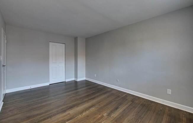 A room with wooden floors and a white door.