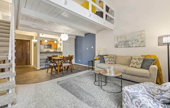 a living room with a couch and a table and a kitchen