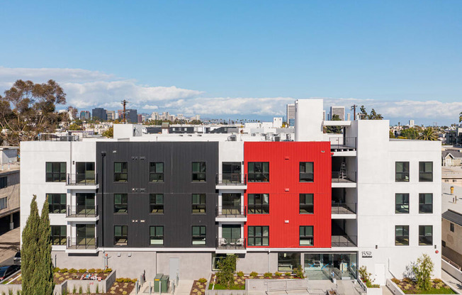 A modern building with a red and black section in the middle.