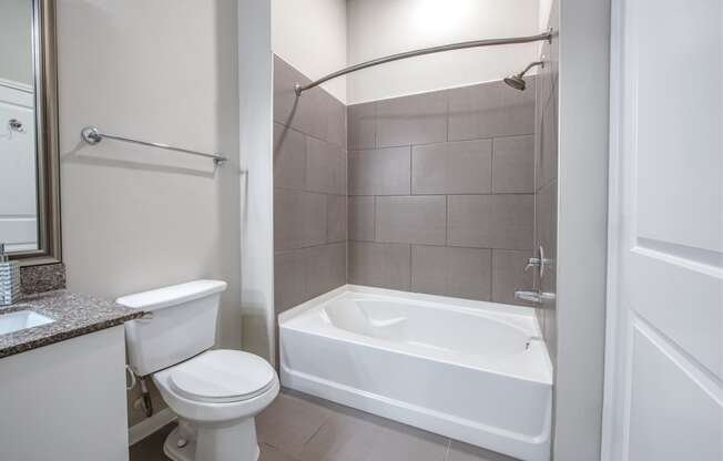 a bathroom with a tub and a toilet and a sink