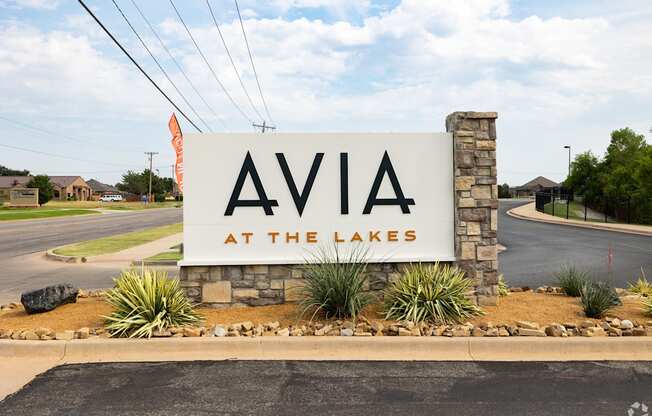 ava at the lakes monument sign on the side of a road