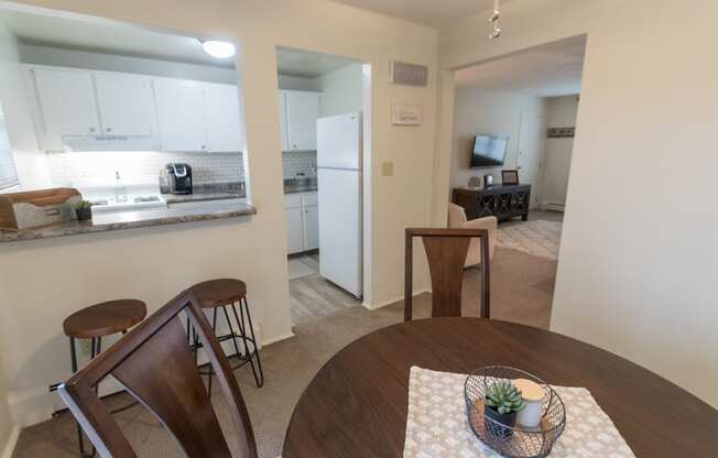 This is a photo of the kitchen and living room from the dining room of the 1 bedroom, 631 square foot model apartment at Lake of the Woods Apartments in Cincinnati, OH.