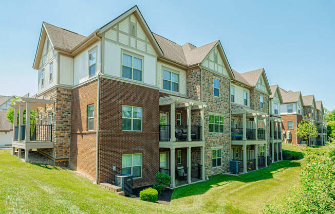 a large brick house with a yard in front of it