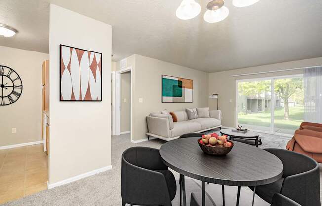 A modern dining room with a round table and chairs.