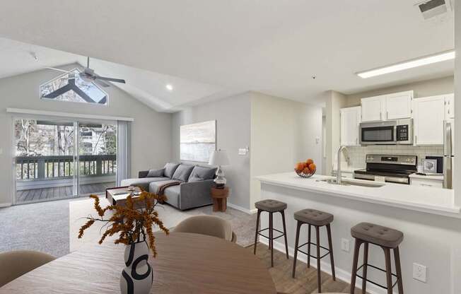 A modern kitchen with a dining table and chairs.