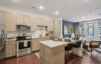 A modern kitchen with wooden cabinets and stainless steel appliances.