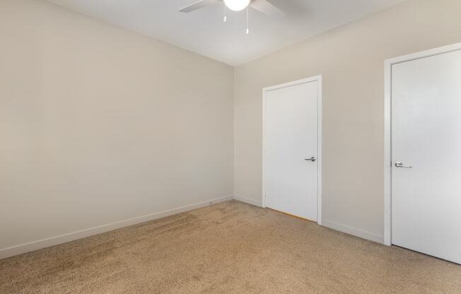 an empty room with white walls and a ceiling fan at Metro Gateway, Riverside