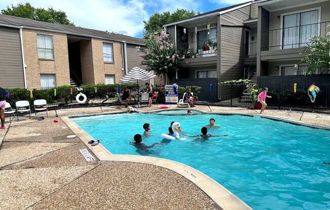 People are enjoying a sunny day at the pool.