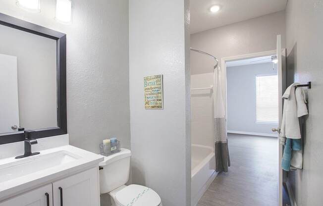 Bathrooms in newly renovated suite with quartz countertops and hardwood-inspired flooring (Legacy Series)