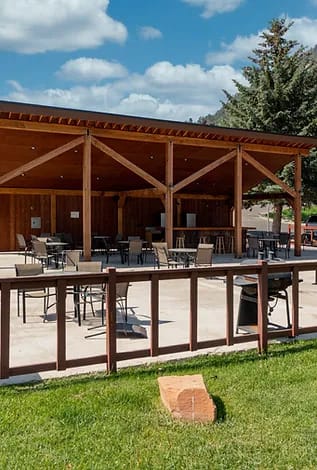 a patio with a wooden fence and awning