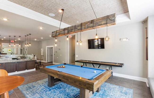 a games room with a pool table and a flat screen tv