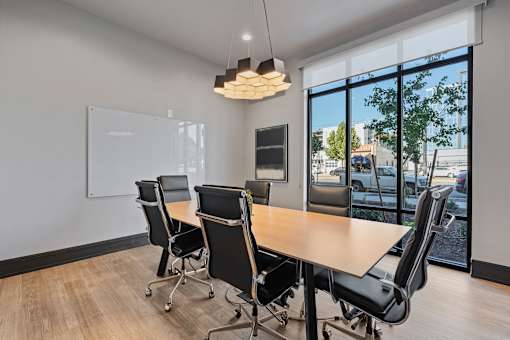 a conference room with a wooden table and chairs at SevenO2 Main Apartments, Salt Lake City, 84101
