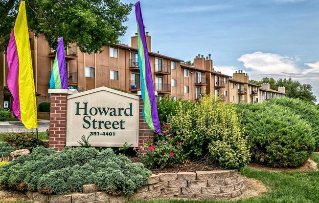 the facade of howard street apartments with colorful flags