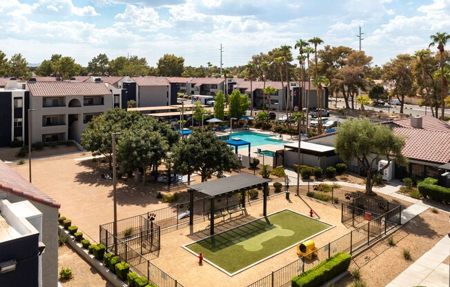 an aerial view of a park with a tennis court and a pool