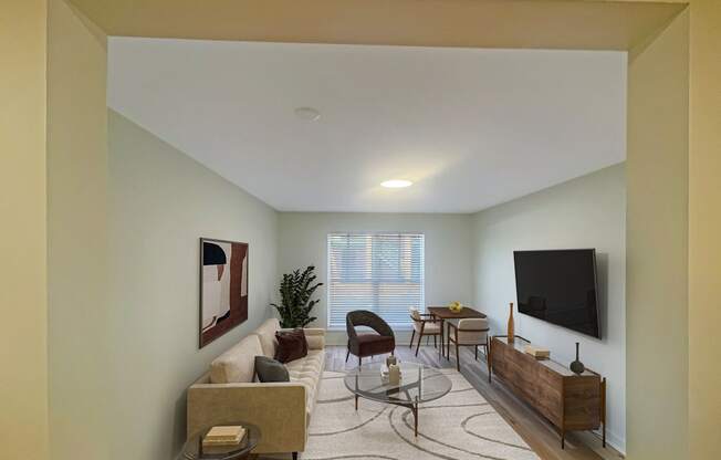 a living room with a couch and a table and a television at The Courts Midtown, Tennessee