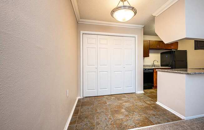 A white door in a room with a brown floor.